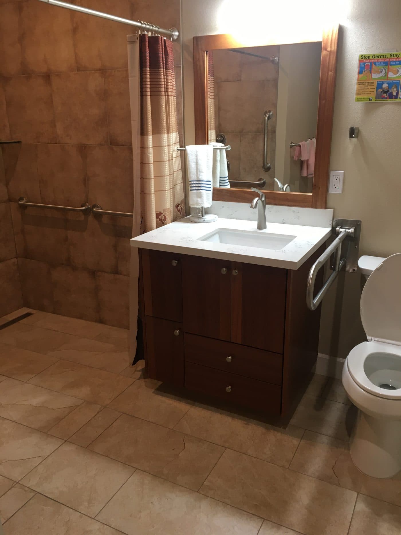 A clean private bathroom with vanity