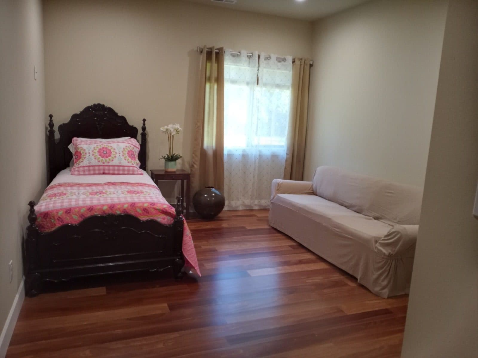 A welcoming, light-filled private guest room